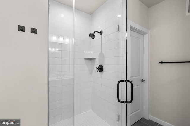 bathroom with a shower with shower door