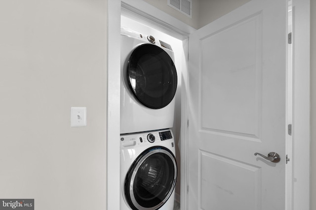 clothes washing area featuring stacked washer / drying machine