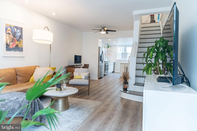 living room with hardwood / wood-style floors and ceiling fan