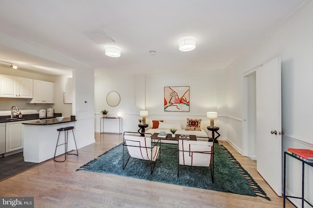 dining area with sink and light wood-type flooring