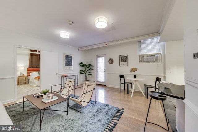 living room with cooling unit and hardwood / wood-style flooring