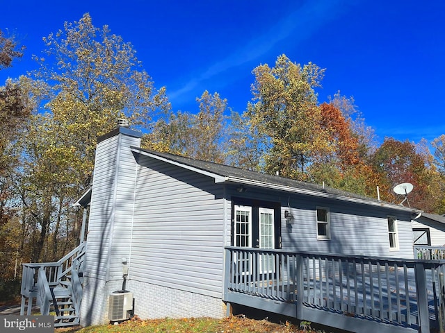 view of side of property with a wooden deck