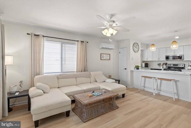 living room with light hardwood / wood-style floors, a wall unit AC, and ceiling fan