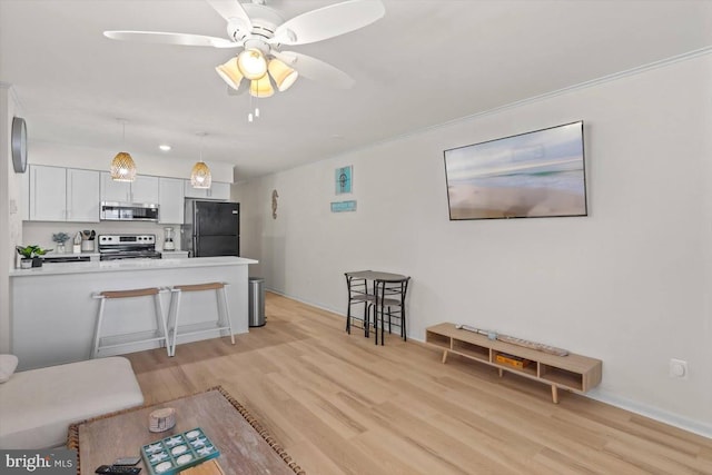 living room with light hardwood / wood-style flooring and ceiling fan