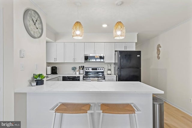 kitchen featuring kitchen peninsula, white cabinets, light stone countertops, and black appliances