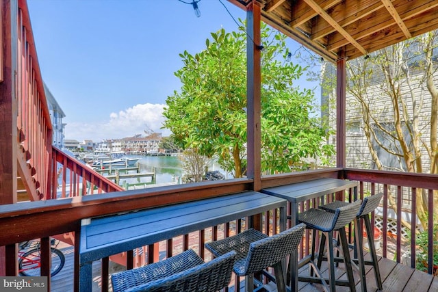 wooden deck featuring a water view