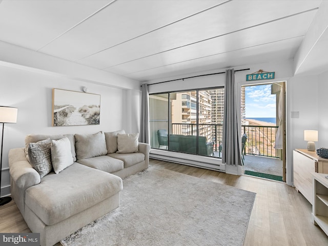 living room with light hardwood / wood-style flooring and a baseboard radiator