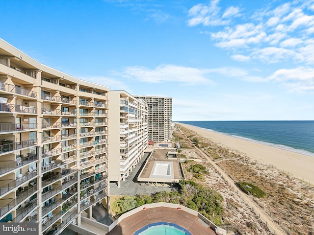 exterior space featuring a water view and a view of the beach