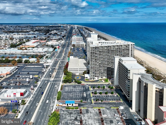 birds eye view of property featuring a water view and a beach view