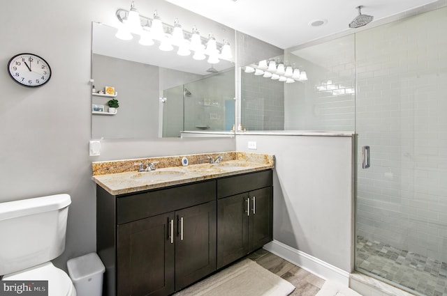 bathroom featuring vanity, hardwood / wood-style floors, toilet, and walk in shower