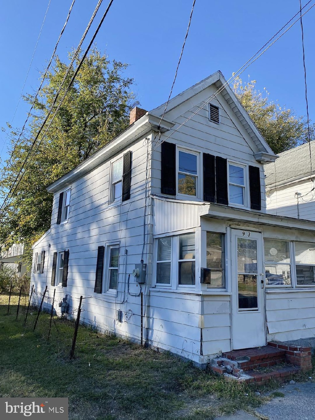 rear view of property with a yard