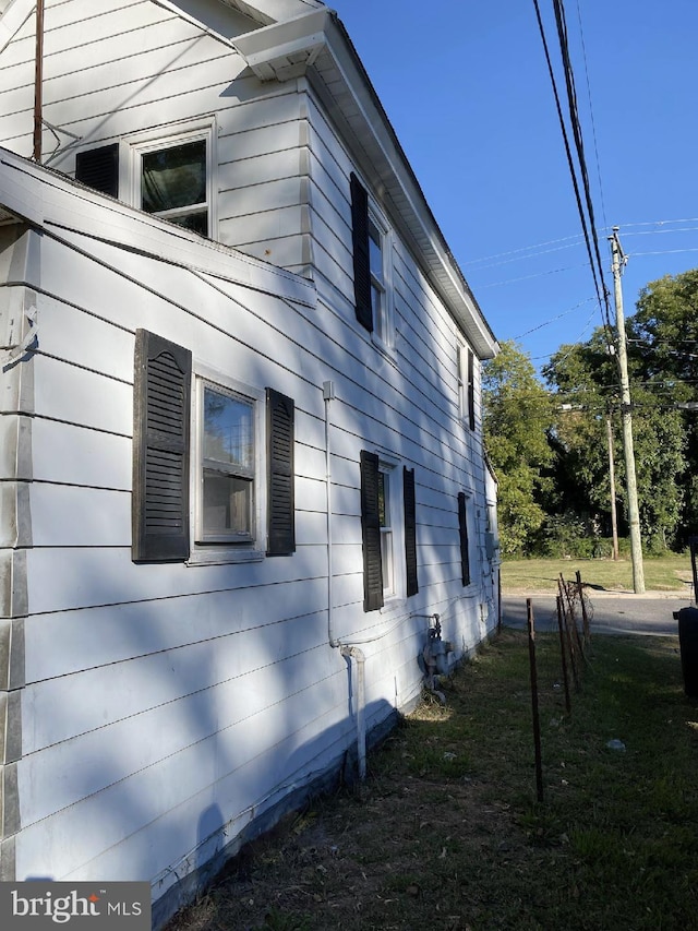 view of property exterior featuring a lawn