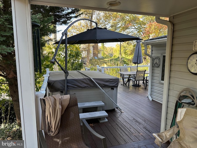 wooden terrace featuring a hot tub