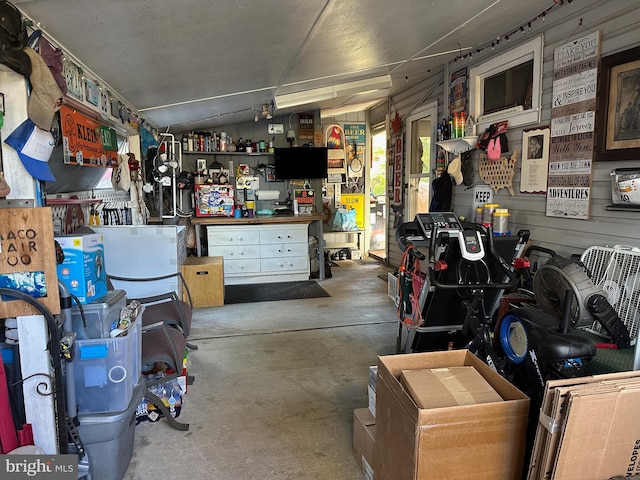 interior space with a workshop area and lofted ceiling