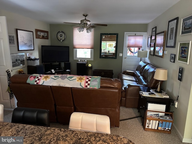 living room with carpet flooring, ceiling fan, and a wealth of natural light