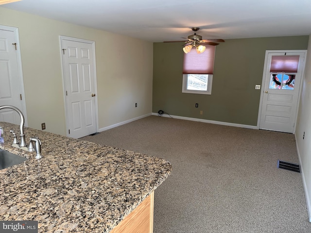 396 Laurel Trl, Crownsville, MD 21032 - interior space featuring a sink, ceiling fan, carpet floors, stone counters, and baseboards