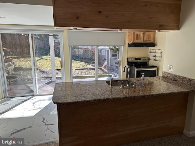 396 Laurel Trl, Crownsville, MD 21032 - kitchen with a peninsula, stainless steel range with electric stovetop, dark stone countertops, a sink, and under cabinet range hood