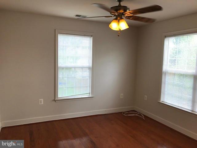 spare room with ceiling fan and hardwood / wood-style floors