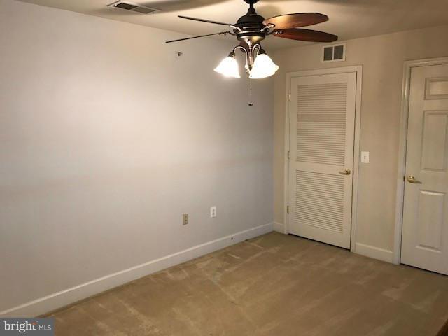 unfurnished bedroom featuring a closet, ceiling fan, and carpet floors