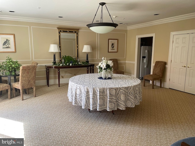 carpeted dining area with crown molding