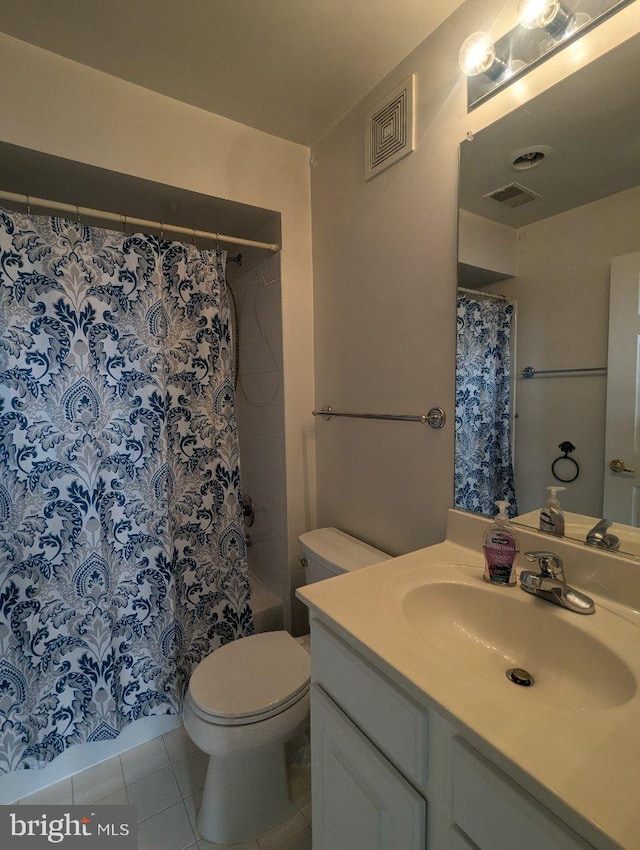 full bathroom with vanity, shower / bath combo with shower curtain, toilet, and tile patterned floors