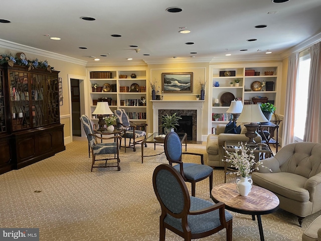 sitting room featuring a premium fireplace, ornamental molding, carpet flooring, and built in shelves