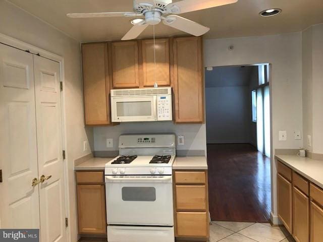 kitchen with white appliances, ceiling fan, and light tile patterned flooring