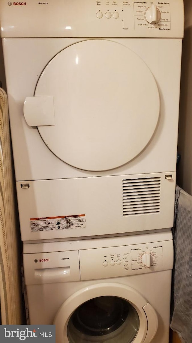 laundry area with stacked washer / drying machine