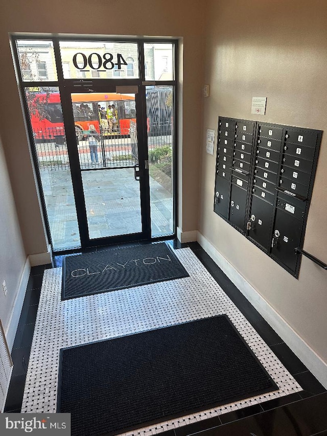 entrance foyer with tile patterned flooring and mail boxes