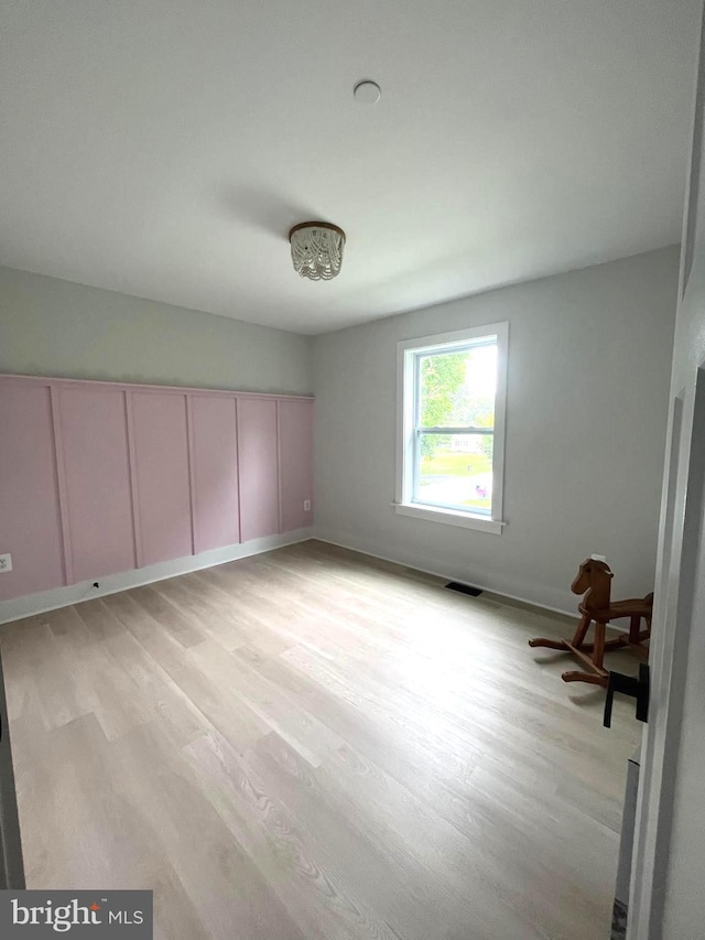 empty room with light hardwood / wood-style floors