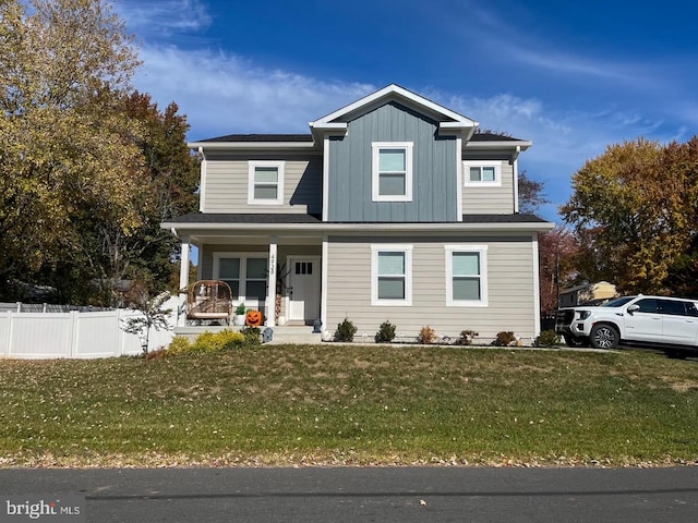 view of front facade featuring covered porch and a front yard