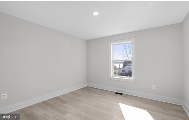 spare room featuring light hardwood / wood-style floors