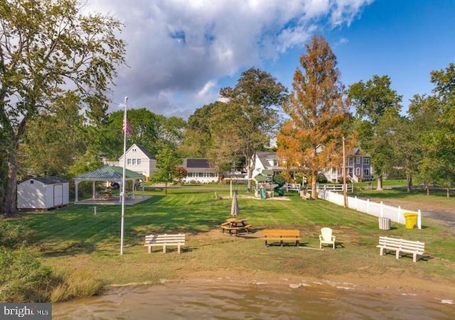 view of yard featuring a gazebo and a water view