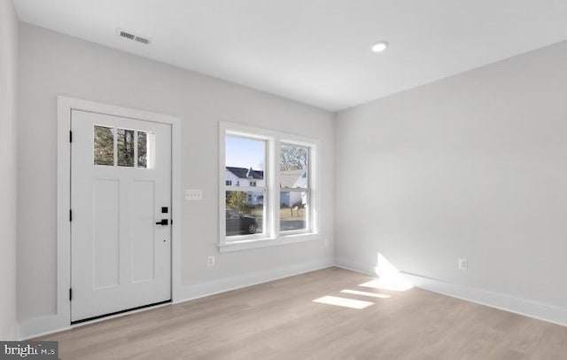 foyer entrance with light hardwood / wood-style floors and a wealth of natural light