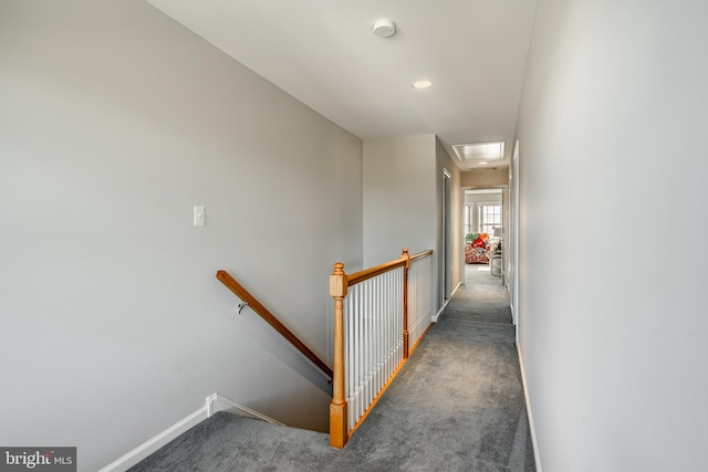 hallway with dark colored carpet