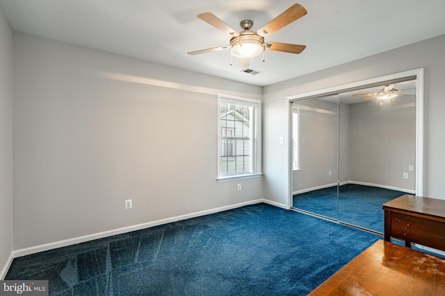 unfurnished bedroom featuring ceiling fan, carpet flooring, and a closet