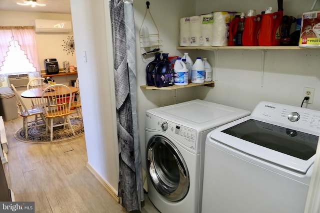 laundry area featuring separate washer and dryer, light wood-type flooring, and a wall unit AC