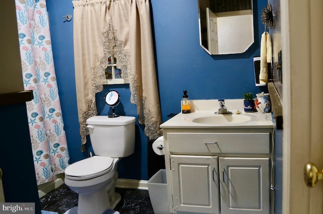 bathroom featuring vanity, toilet, and curtained shower