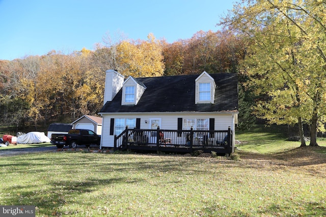 view of front of home with a front yard and a deck