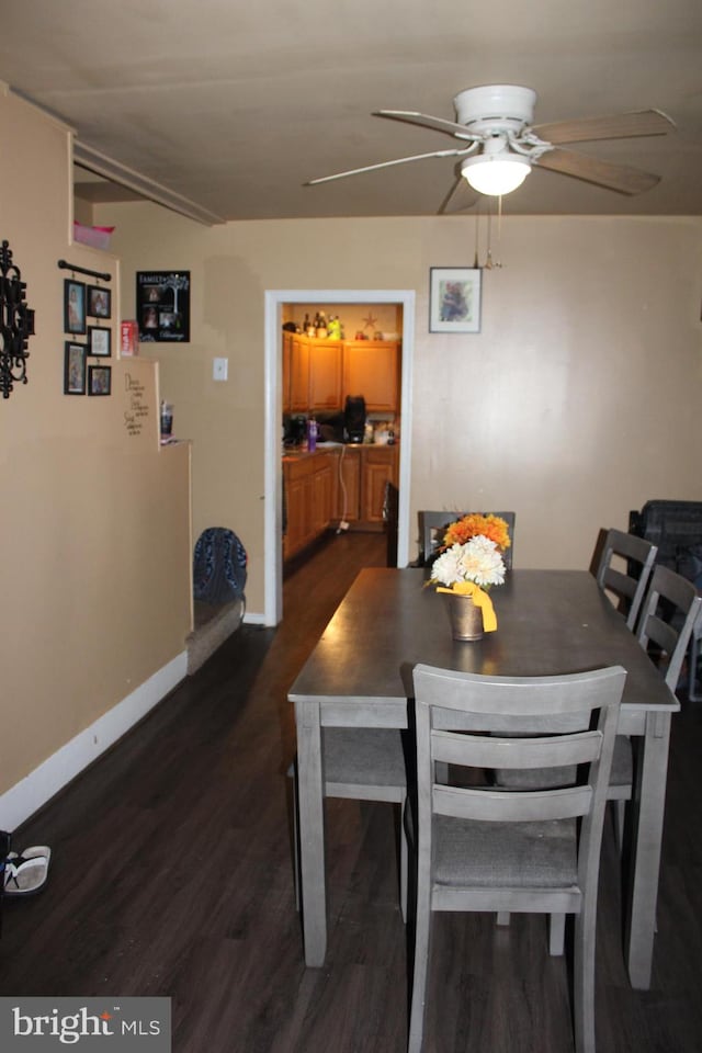 dining space featuring ceiling fan and dark hardwood / wood-style flooring