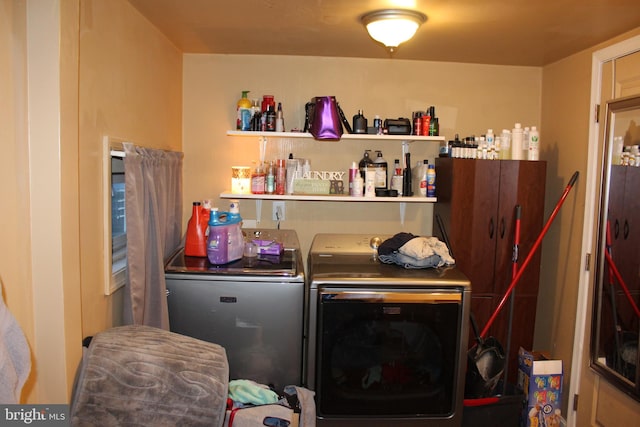 clothes washing area with washing machine and dryer