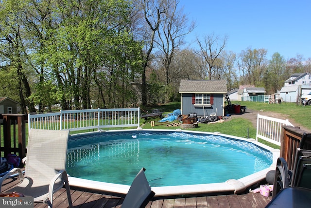 view of pool with an outdoor structure and a yard