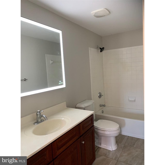 full bathroom with vanity, toilet, and tiled shower / bath combo