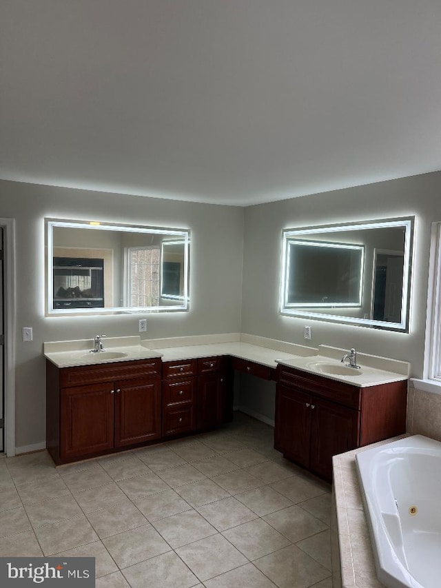 bathroom with vanity, a relaxing tiled tub, and a wealth of natural light