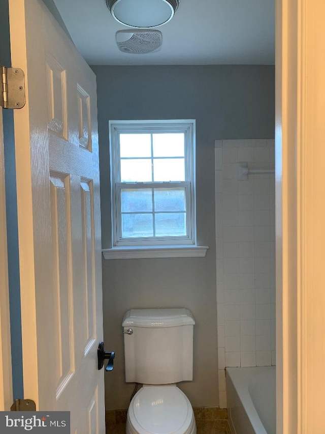 bathroom featuring toilet and tile patterned floors