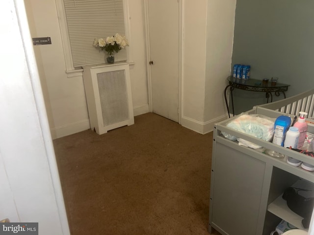 carpeted bedroom with a nursery area