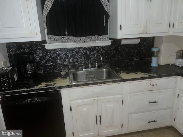 kitchen featuring black dishwasher, sink, backsplash, and white cabinets