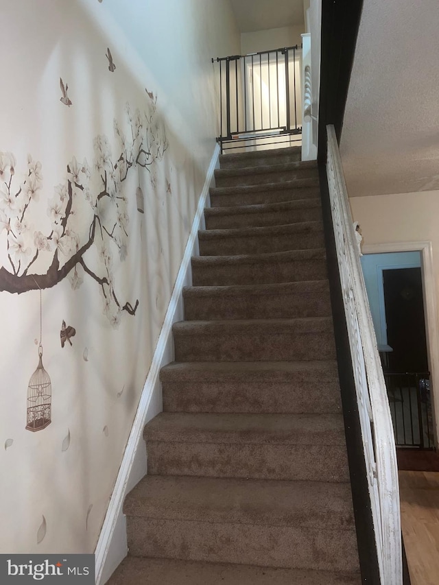 staircase featuring wood-type flooring