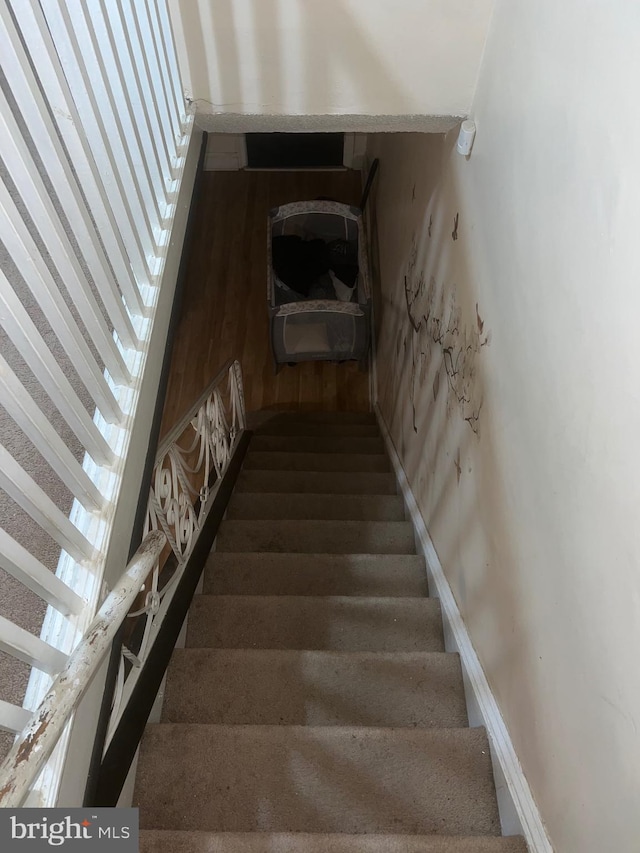 staircase featuring hardwood / wood-style floors