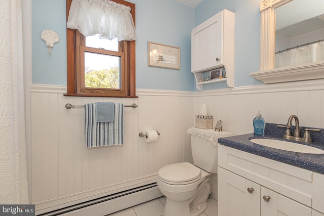 bathroom featuring vanity, toilet, baseboard heating, and tile patterned flooring